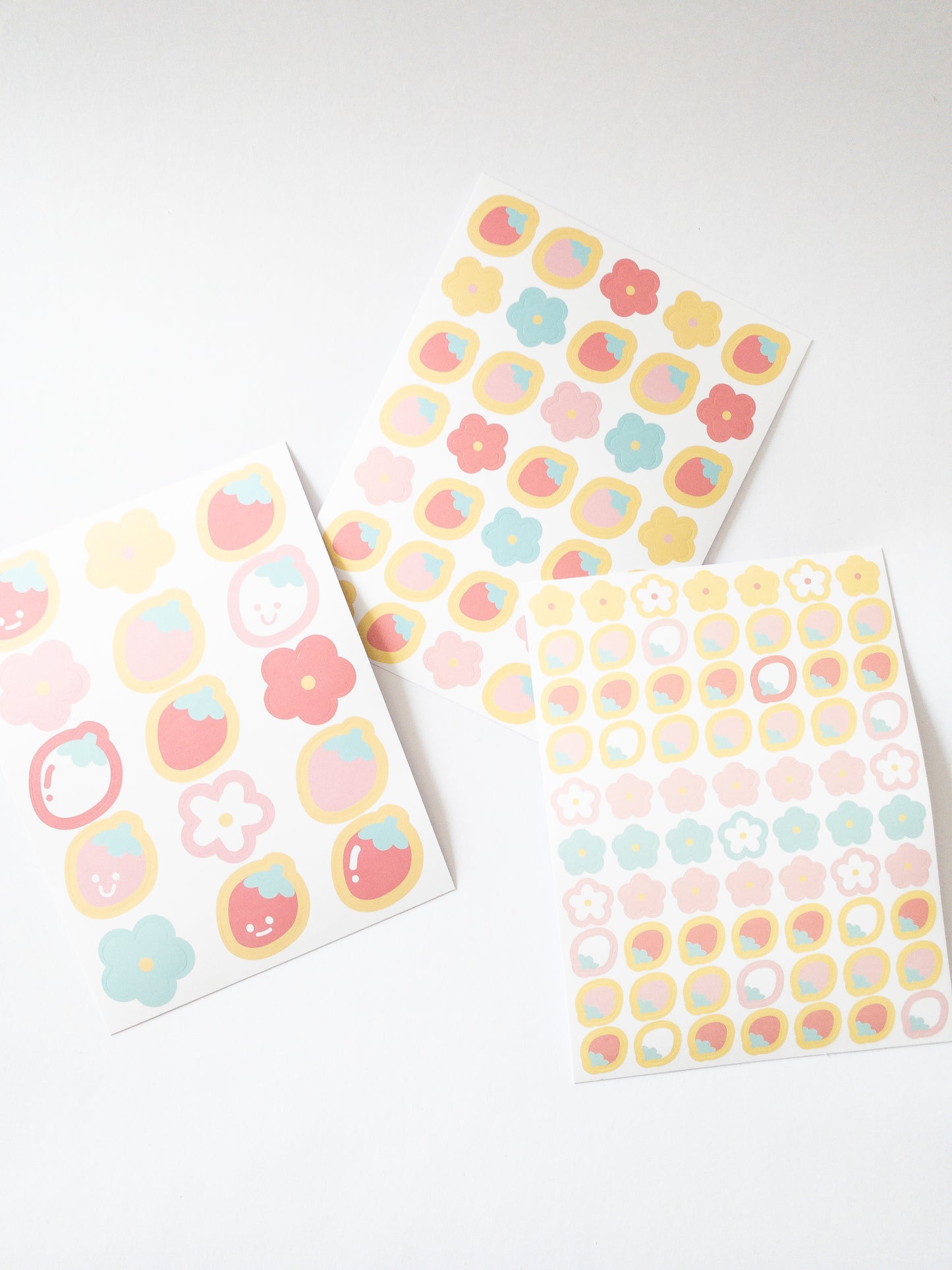 120 Korean style stickers! Three sheets of berry floral goodness. There are 70 mini flowers and strawberries, 35 medium-sized stickers and 15 large happy, smiley strawberries and flowers.