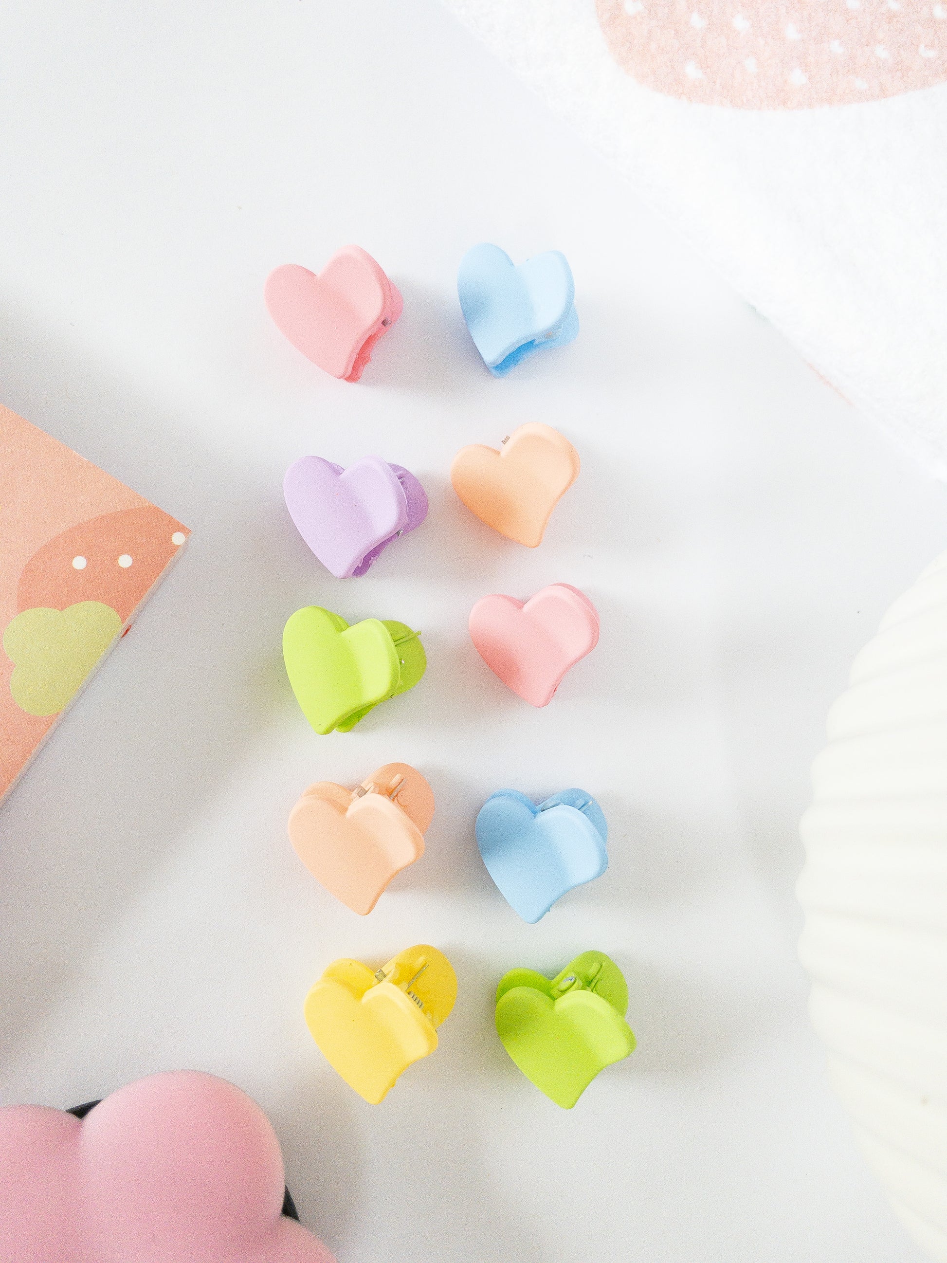 Matte, lovable, and eenie mini. This pack of 10 mini hearts come in an a mix of colors and are the cutest little hair claw clips to give your hairstyle that playful look.
