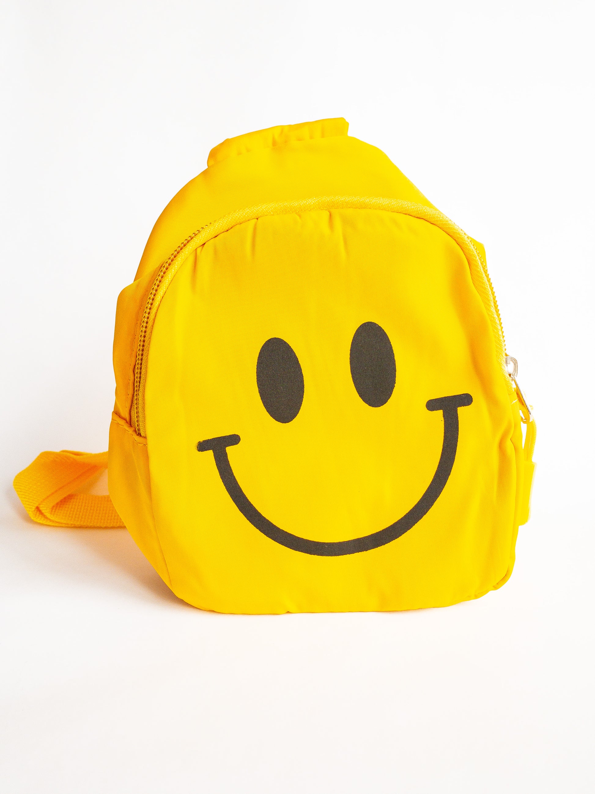 Just a slice of instant happiness. This cute smiley face crossbody or slingback bag is the perfect size for kids. It has a cable cord pull zipper which opens up to a single compartment and is super lightweight with adjustable straps. Wear it front or back.