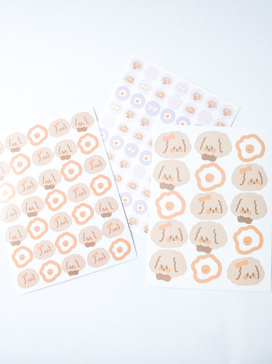 120 Korean style stickers! Three sheets of cute fluffy girl and boy puppies and fried eggs and more. There are 70 mini stickers, 35 medium-sized stickers and 15 large stickers.