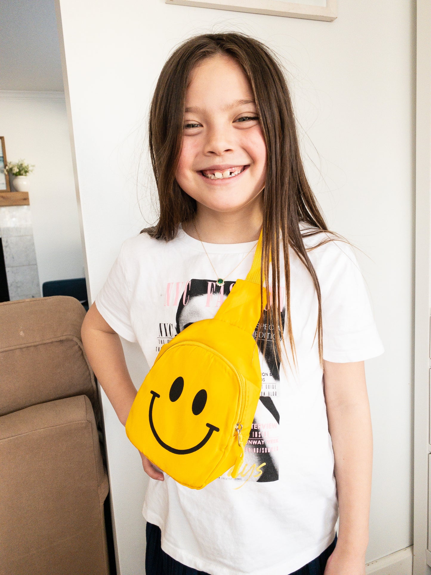 Just a slice of instant happiness. This cute smiley face crossbody or slingback bag is the perfect size for kids. It has a cable cord pull zipper which opens up to a single compartment and is super lightweight with adjustable straps. Wear it front or back.