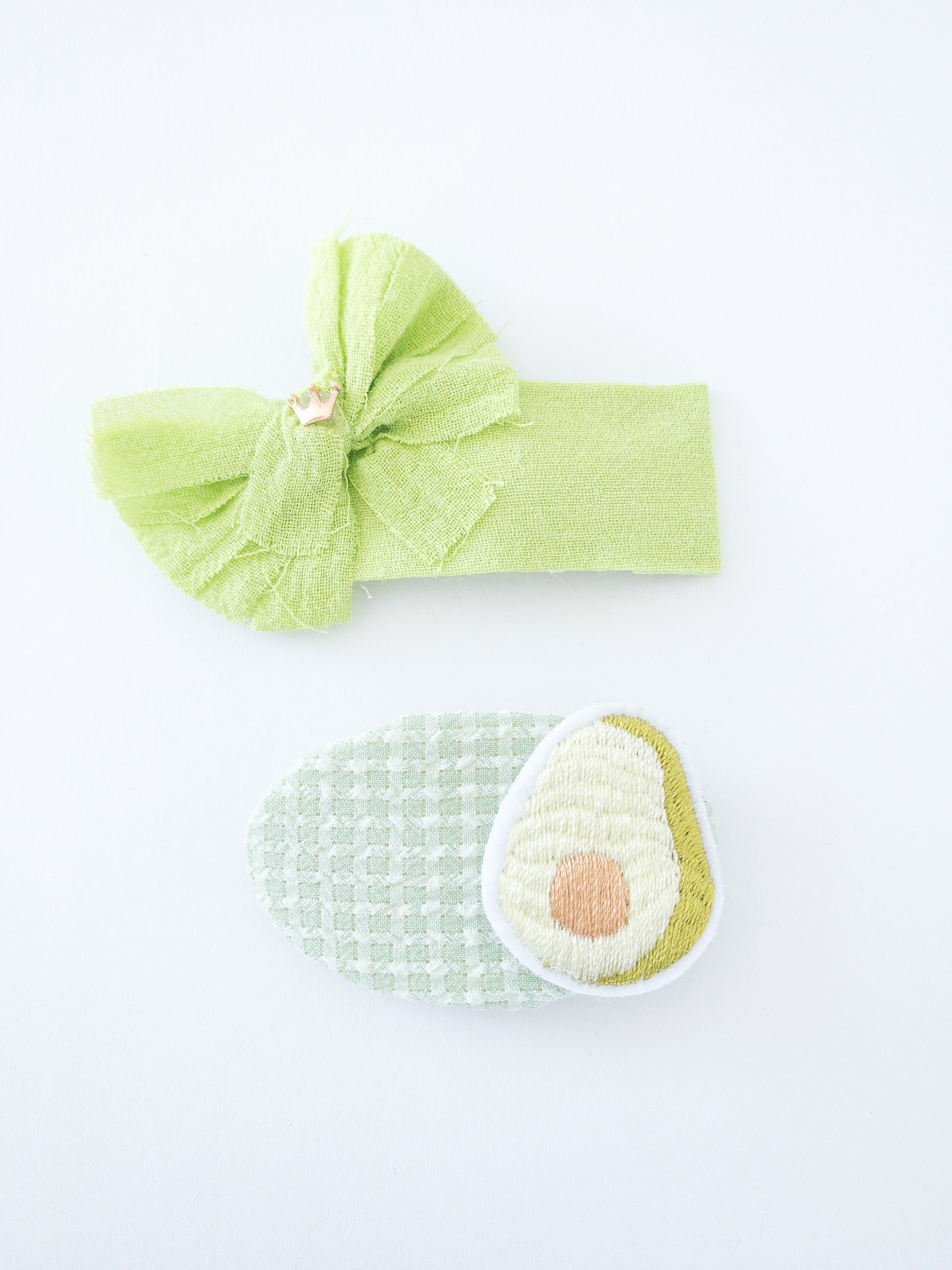 A pretty, fabric wrapped barrette duo! Each fruit is a different color. One oval barrette is wrapped in a soft gingham fabric with a cute fruit patch attached. The other is a rectangle barrette wrapped in a solid color fabric with a fabric bow and tiny gold crown attached. Each barrette is a snap clip. Four different fruits to choose from, get one of each!