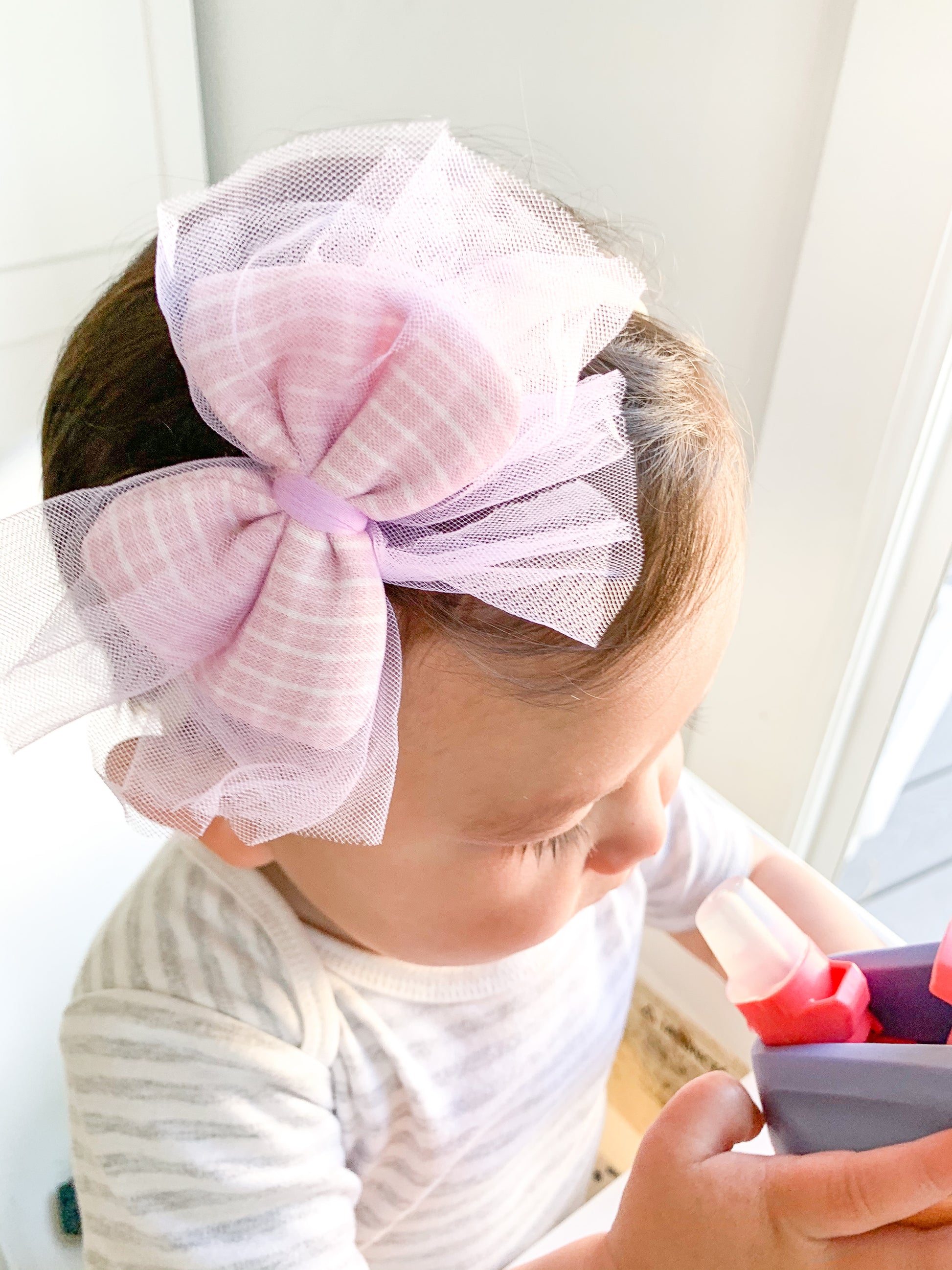 This set is so whimsical! Each set comes with 2 headbands. Each bow, in both pink and blue, is a plaid pattern which is then encased in this beautiful, soft and airy tulle.   Great for kids with little to no hair. The nylon elastic is super stretchy and super soft.