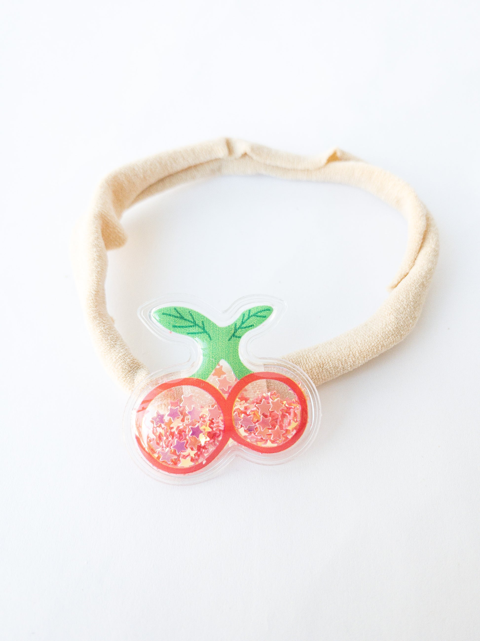 Our most popular shaker fruits now as baby bands! Six different cute fruits to choose from: strawberry, grapes, banana, carrot, cherry, and pineapple. Each shaker fruit is filled with tiny shimmery colorful star confetti. Make your own set, mix and match them!   Great for kids with little to no hair. The nylon elastic is super stretchy and super soft.