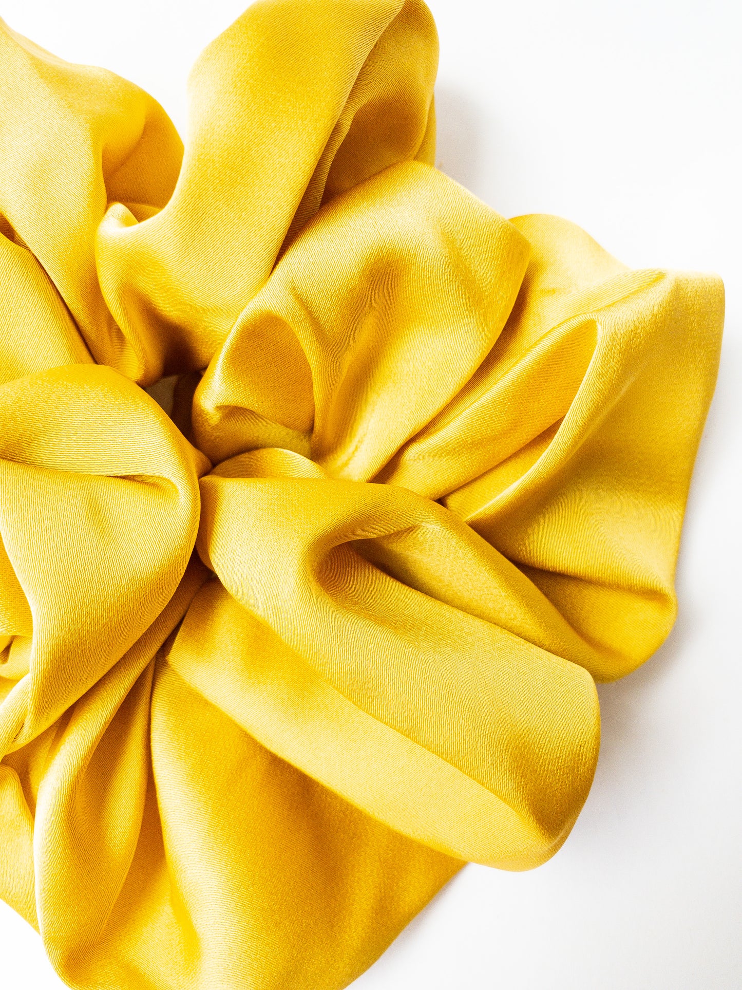 Rich and buttery soft jumbo oversized scrunchie in a beautiful turmeric yellow sheen. Perfect for holding curls and easily creating a romantic hairstyle. 