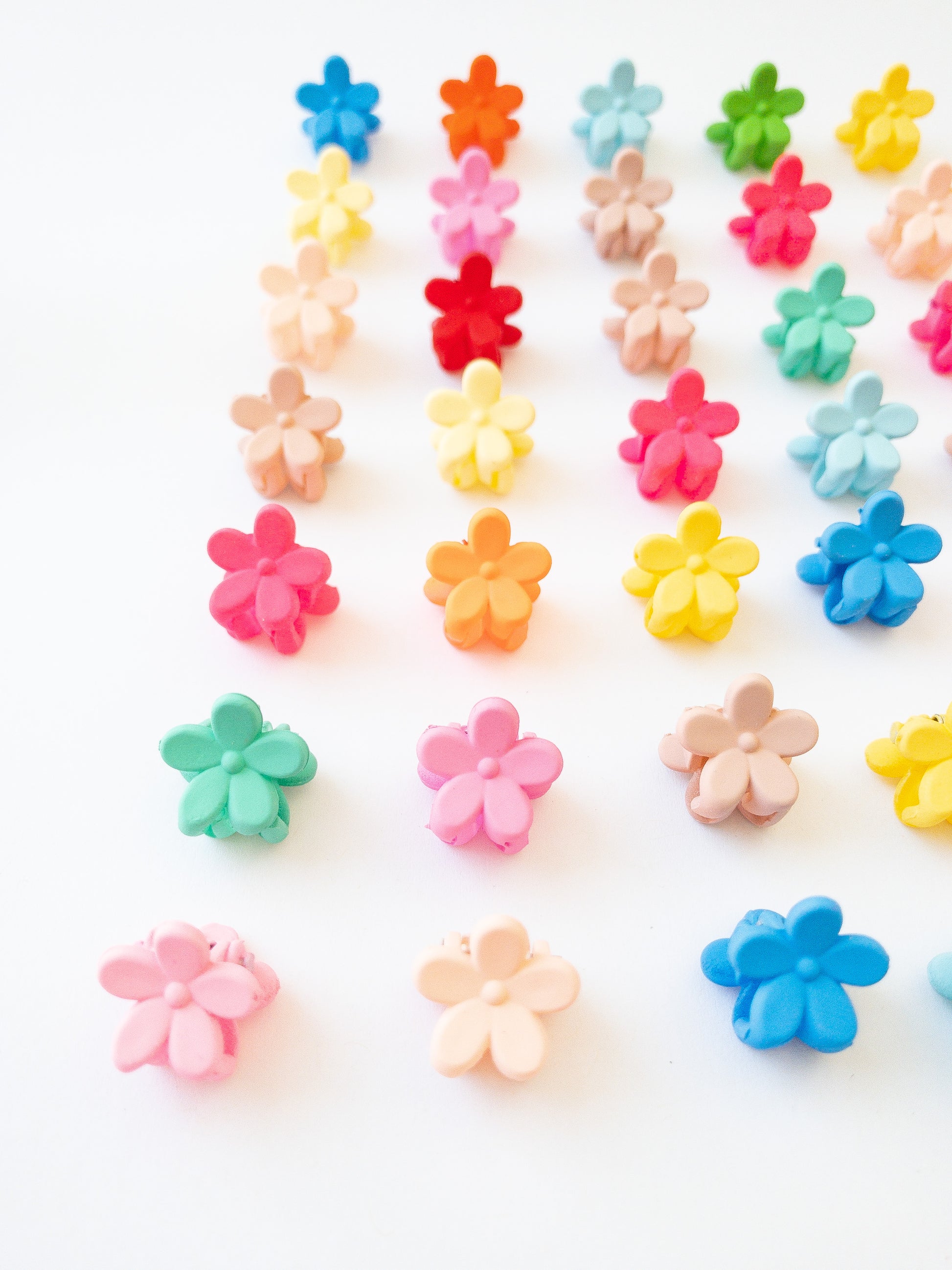 Our signature Korean style mini flower hair clips! Each hair clip is only half an inch in length and is great for clipping your hair back in pretty garden rows or using one or two to keep your hair from your face. Each box comes with 36 dainty pieces in a variety of pretty colors in our very own Eggy Cakes box. These really are a must have!