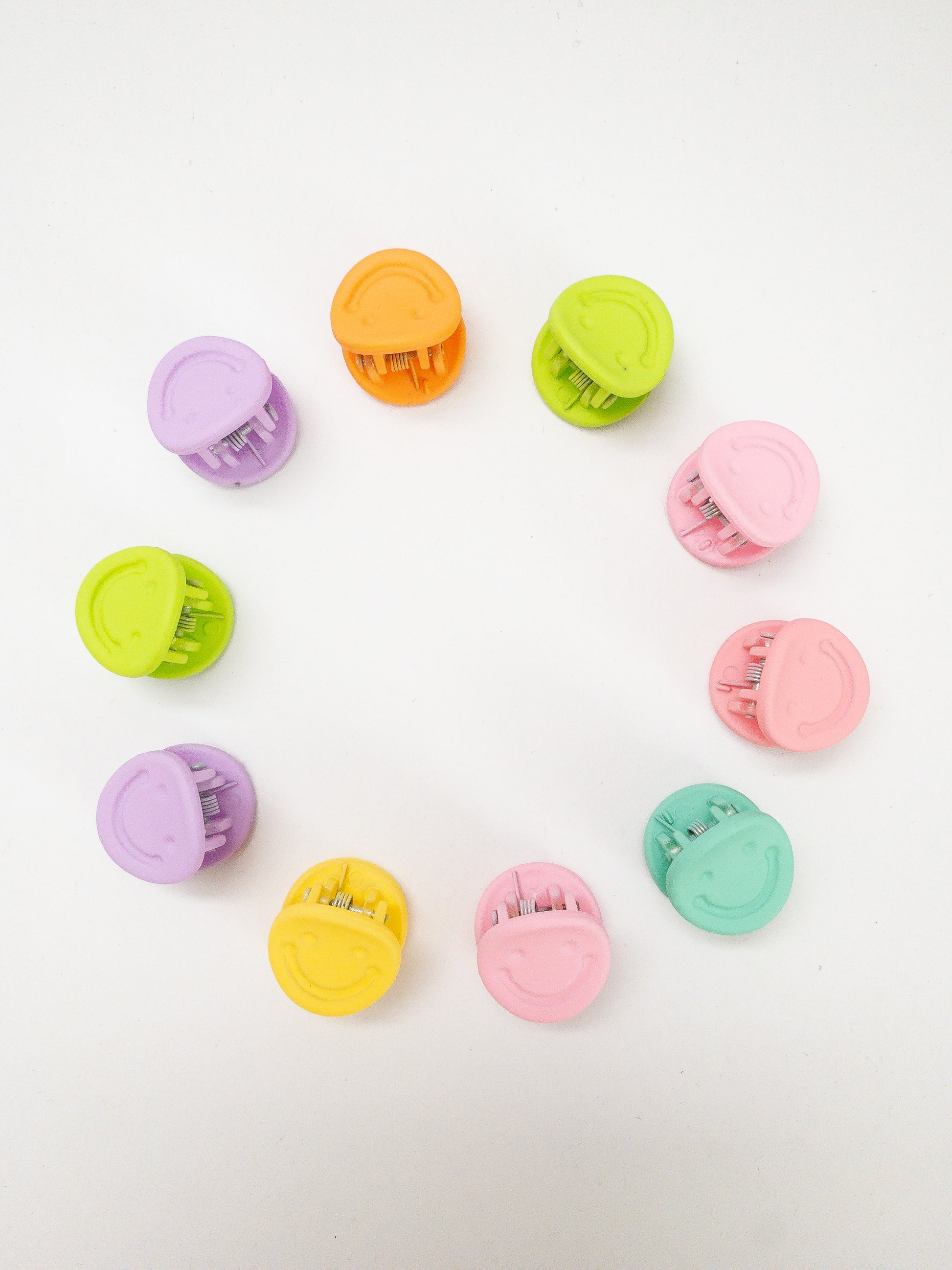 A 10-pack assortment of happy little smiley face hair claws. These are not mini sized but a little bigger at .75" in length. They're strong and stay in place and come in a variety of pretty frosted colors. Korean hair accessories, Korean accessories, Korean mini hair clips, Korean hair clips, Korean style hair accessories