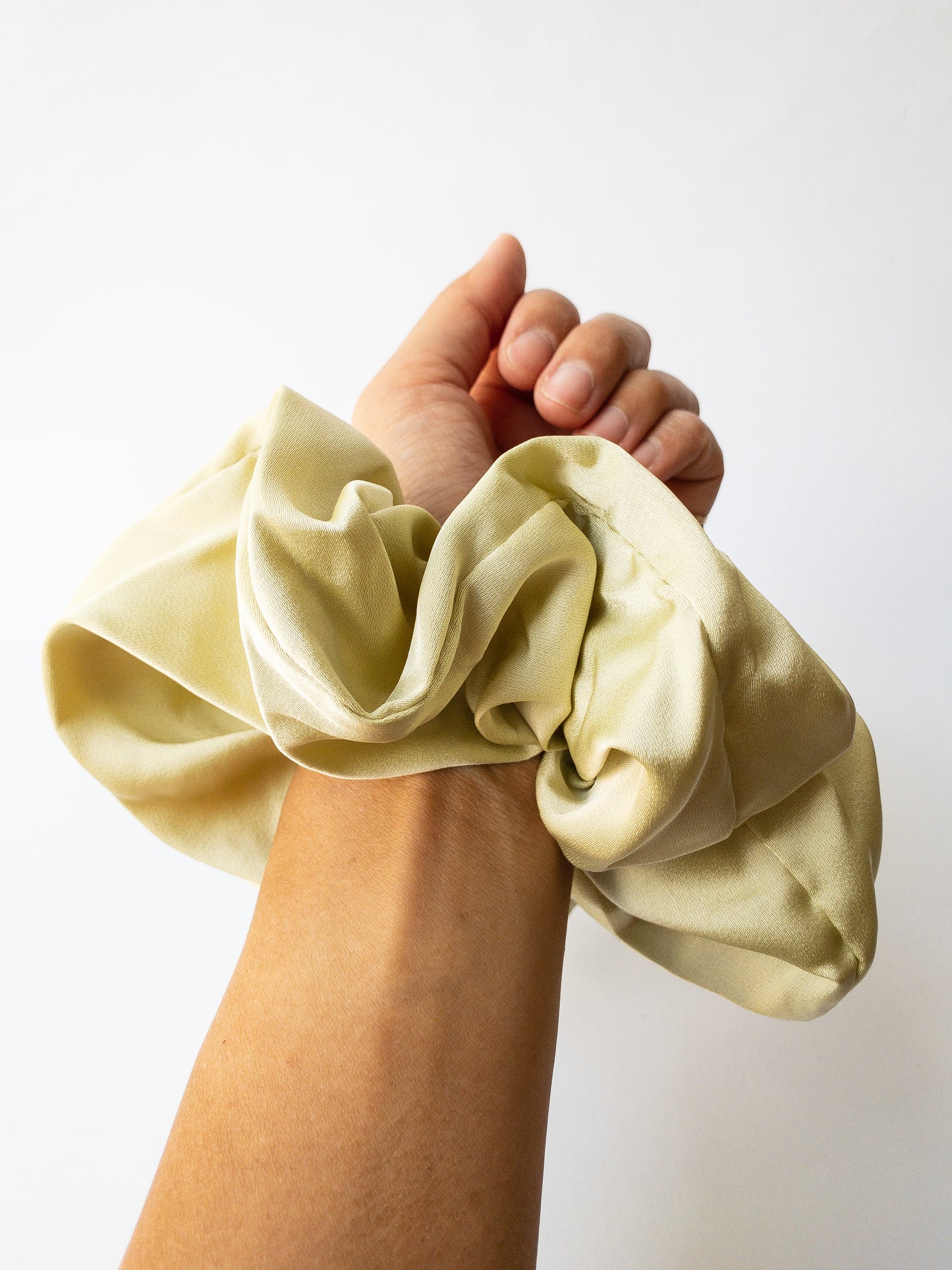 Rich and buttery soft jumbo oversized scrunchie in a beautiful sage green sheen. Perfect for holding curls and easily creating a romantic hairstyle. 