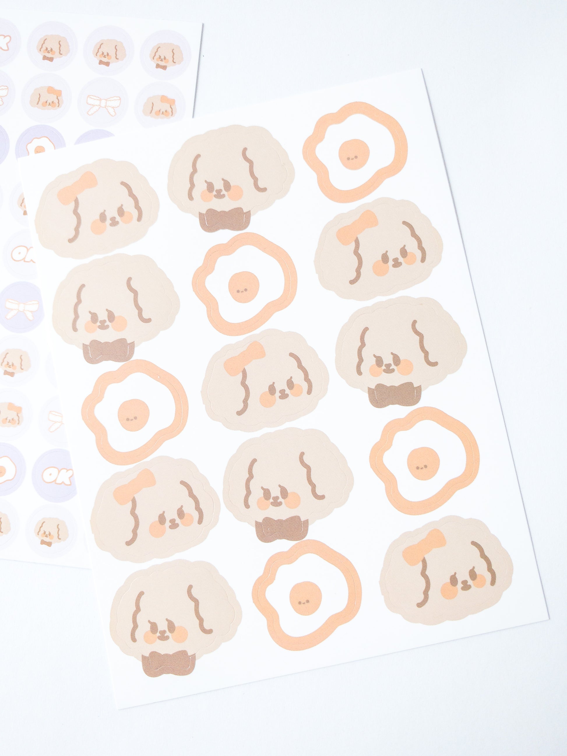 120 Korean style stickers! Three sheets of cute fluffy girl and boy puppies and fried eggs and more. There are 70 mini stickers, 35 medium-sized stickers and 15 large stickers.