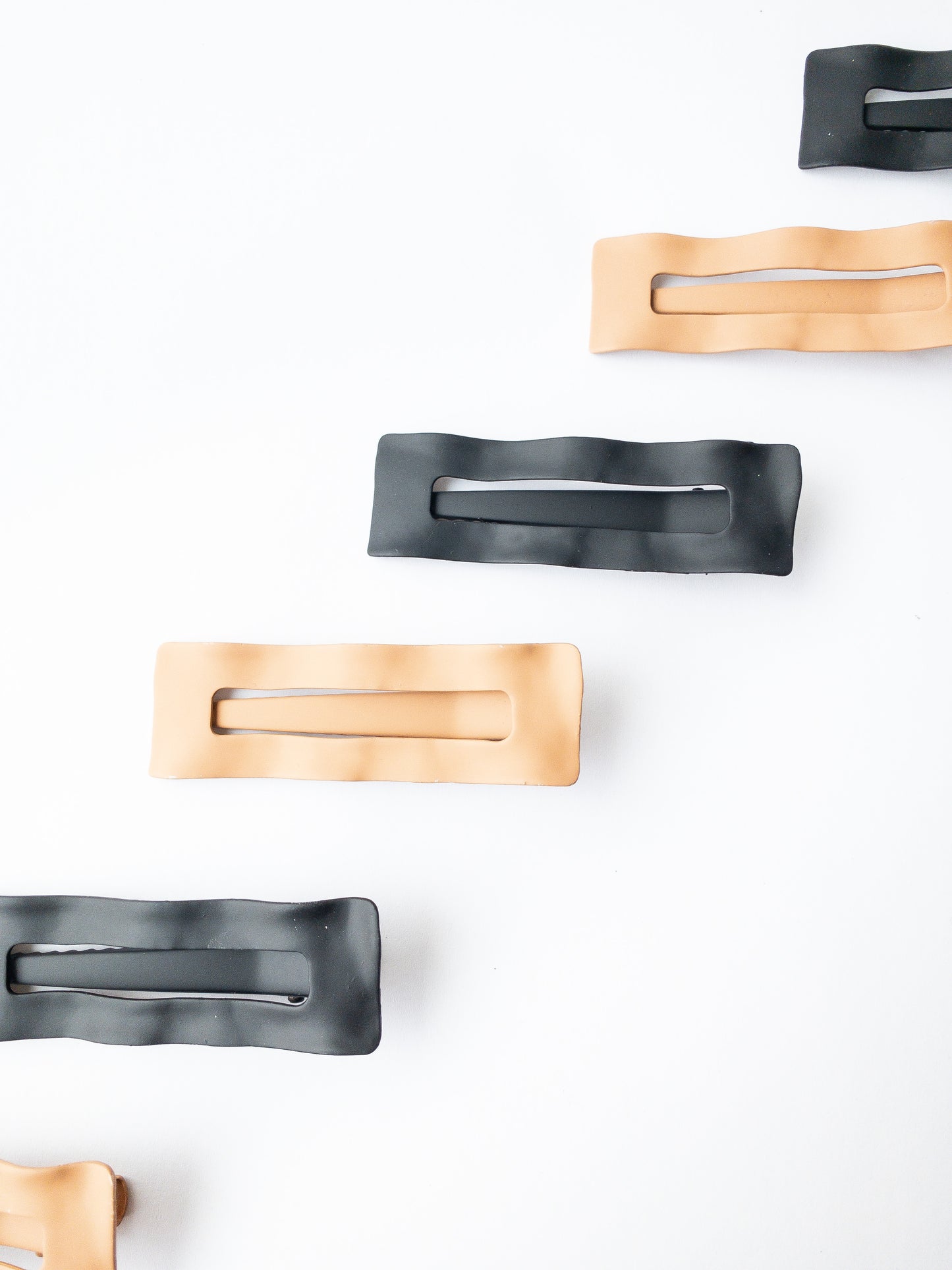 Wavy and chic, these barrettes come in two very modern matte colors: latte and black. These grip so well! And are sturdy yet lightweight to hold your hair beautifully. 