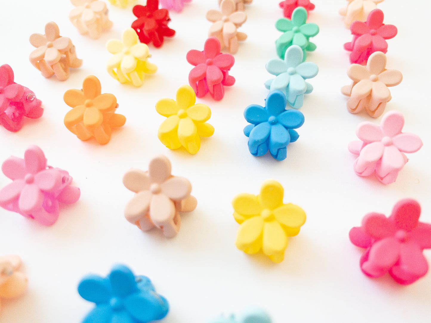 Our signature Korean style mini flower hair clips! Each hair clip is only half an inch in length and is great for clipping your hair back in pretty garden rows or using one or two to keep your hair from your face. Each box comes with 36 dainty pieces in a variety of pretty colors in our very own Eggy Cakes box. These really are a must have!