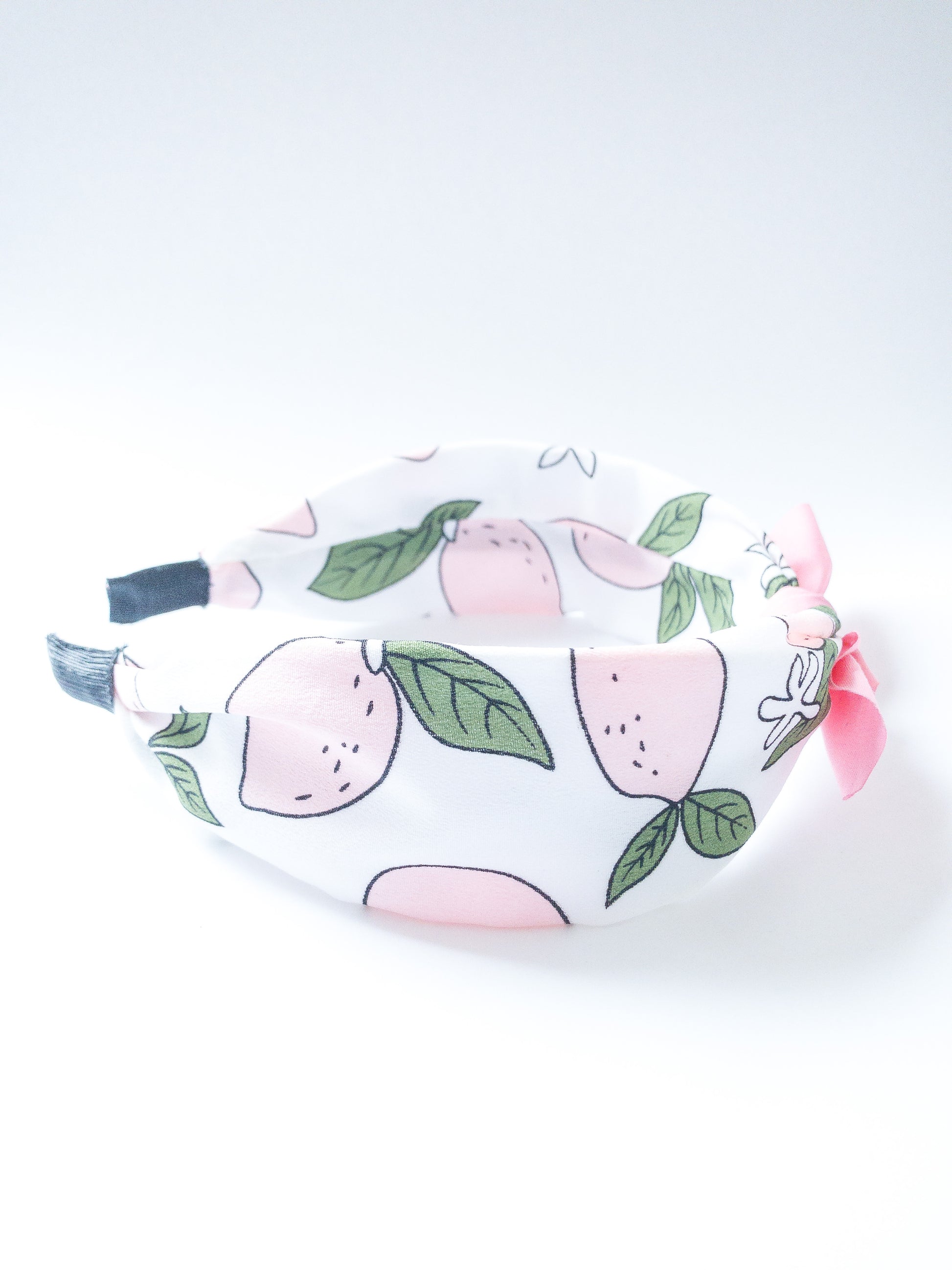 Not only is this headband so so cute, but it is also very comfortable! Each headband is wrapped in a silky fruit patterned fabric with a solid color bow at the top. The ends are also wrapped in fabric. Choose from four different fruits/colors. Best suited for a child.