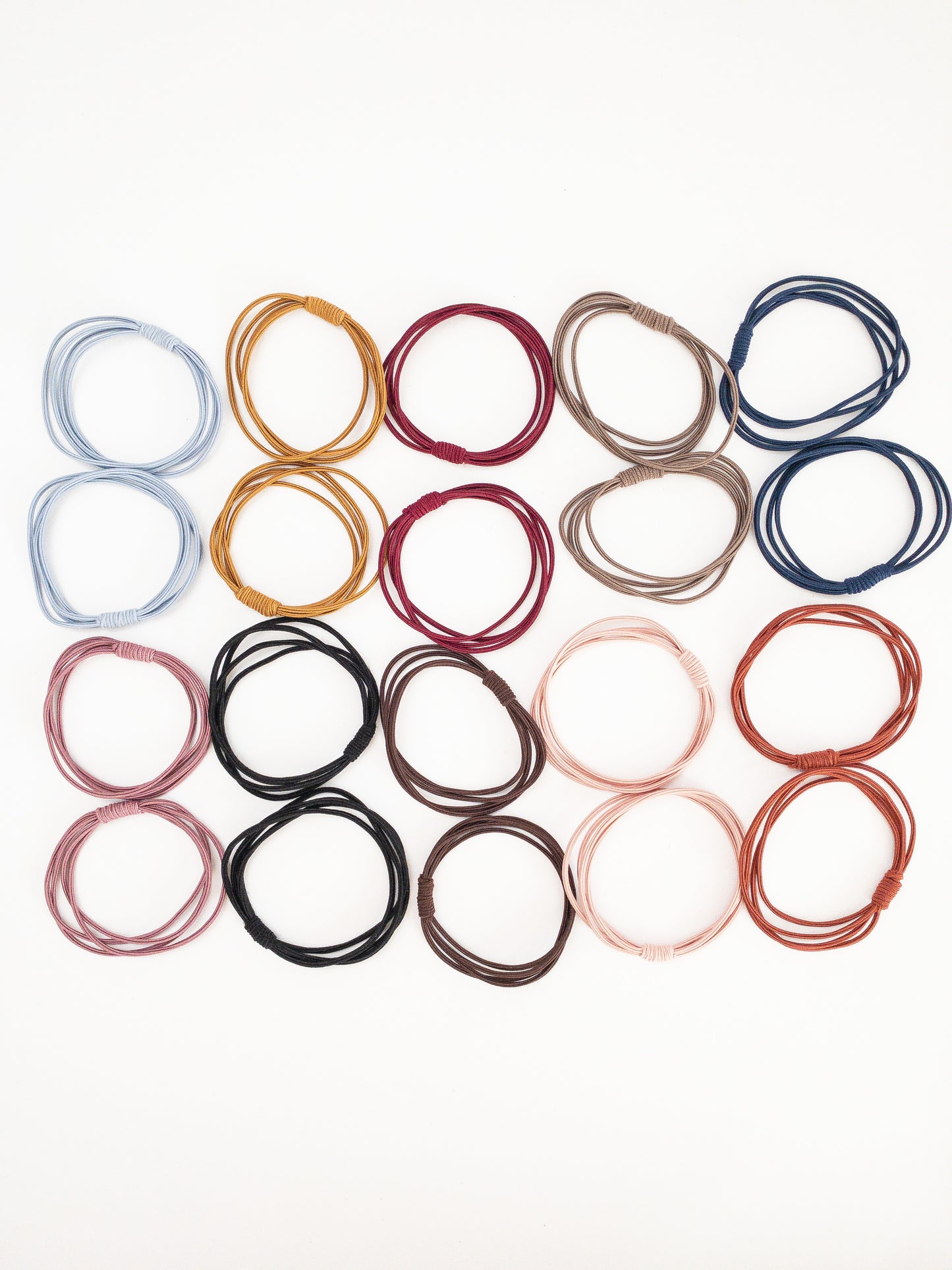 A much needed set of 20 hair ties! Each hair tie has four strands wrapped around and tied with a pretty coil. There are two of each color: black, plum, mustard, light pink, navy, dark brown, mauve, light blue, gray, and copper. Korean hair ties, Korean hair accessories, Korean accessories, Korean hair rubber bands