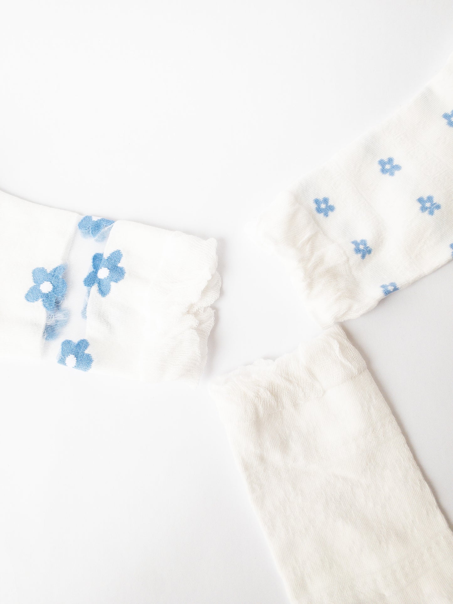 A soft floral socks set of 3 of the gentlest socks with tender ruffles. One pair is classic white and blue, one pair has delicate blue flowers throughout, and one pair is solid white with a sheer peekaboo floral lace.  Adult size 4-10, crew socks length.
