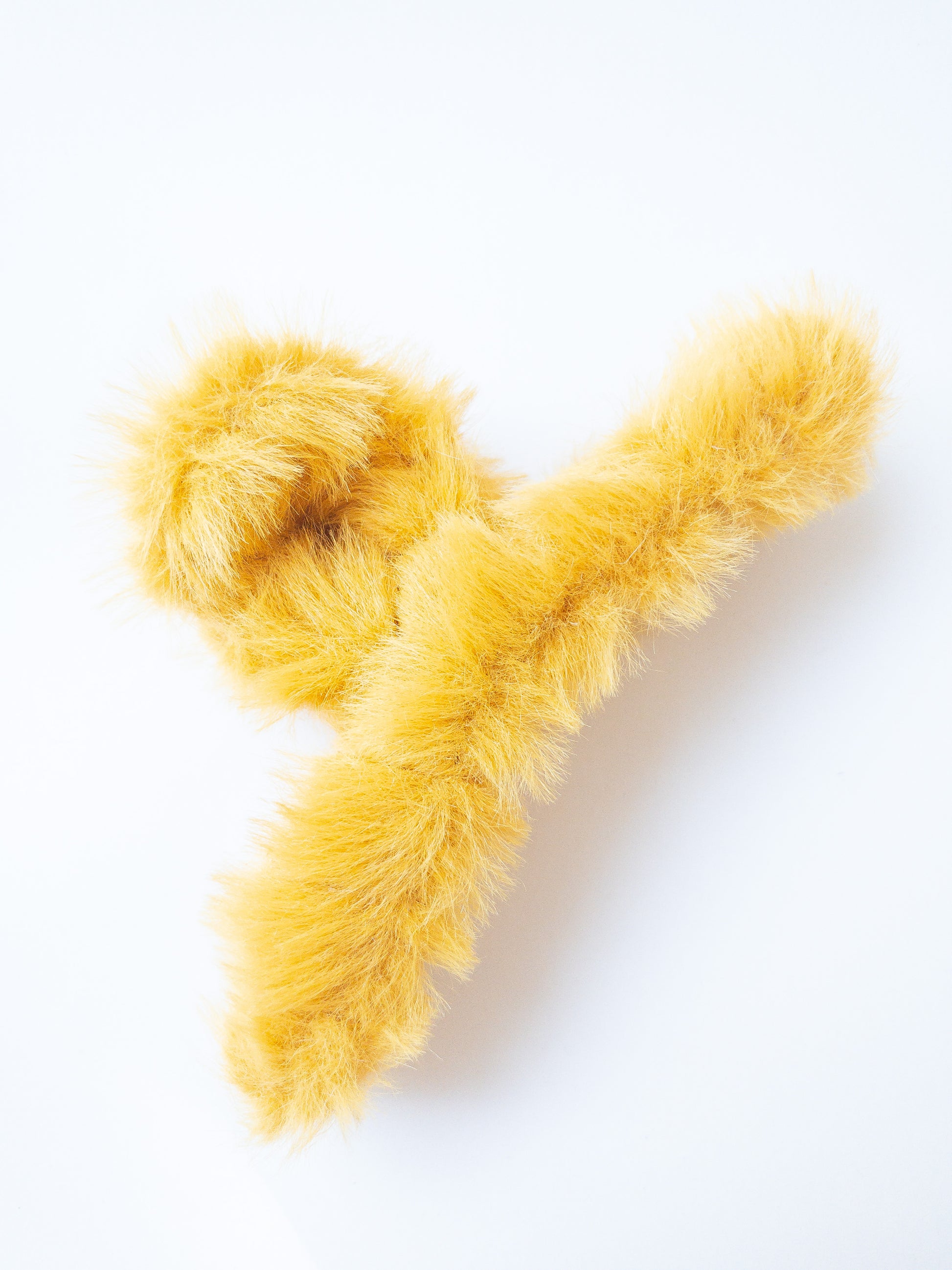 Just pure softness in a hair claw. Each transparent loop hair claw is wrapped in a furry soft yellow fabric for those easy to grab, messy hair days.